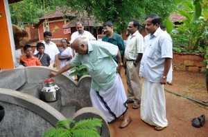 MP Virendra Kumar (MD of Mathrubhumi) paying a visit at the temple with the Idakka. Kalyanikutti Amma is seen 4th from L, in the background is the house she stays and the land she donated